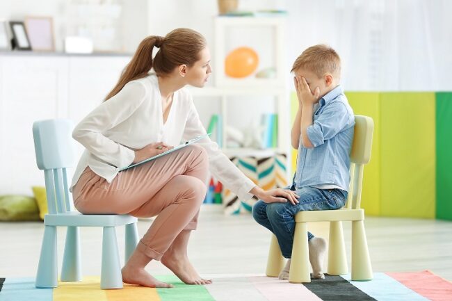 Young female psychologist working with little boy in office İstanbul Psikiyatrist